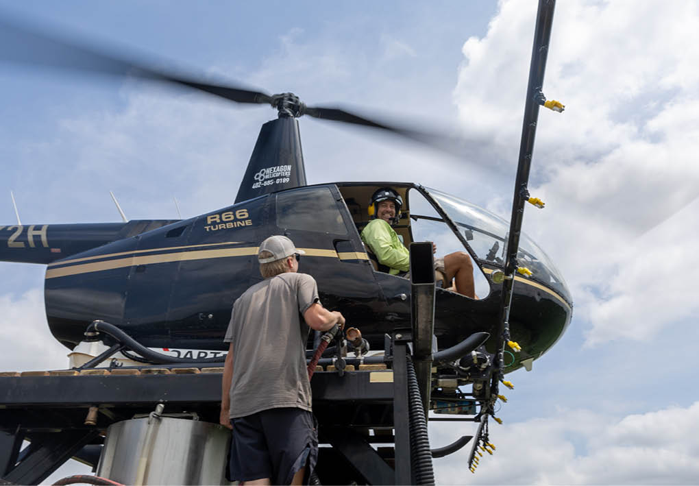 A man is standing on a platform next to a helicopter. AI generated content