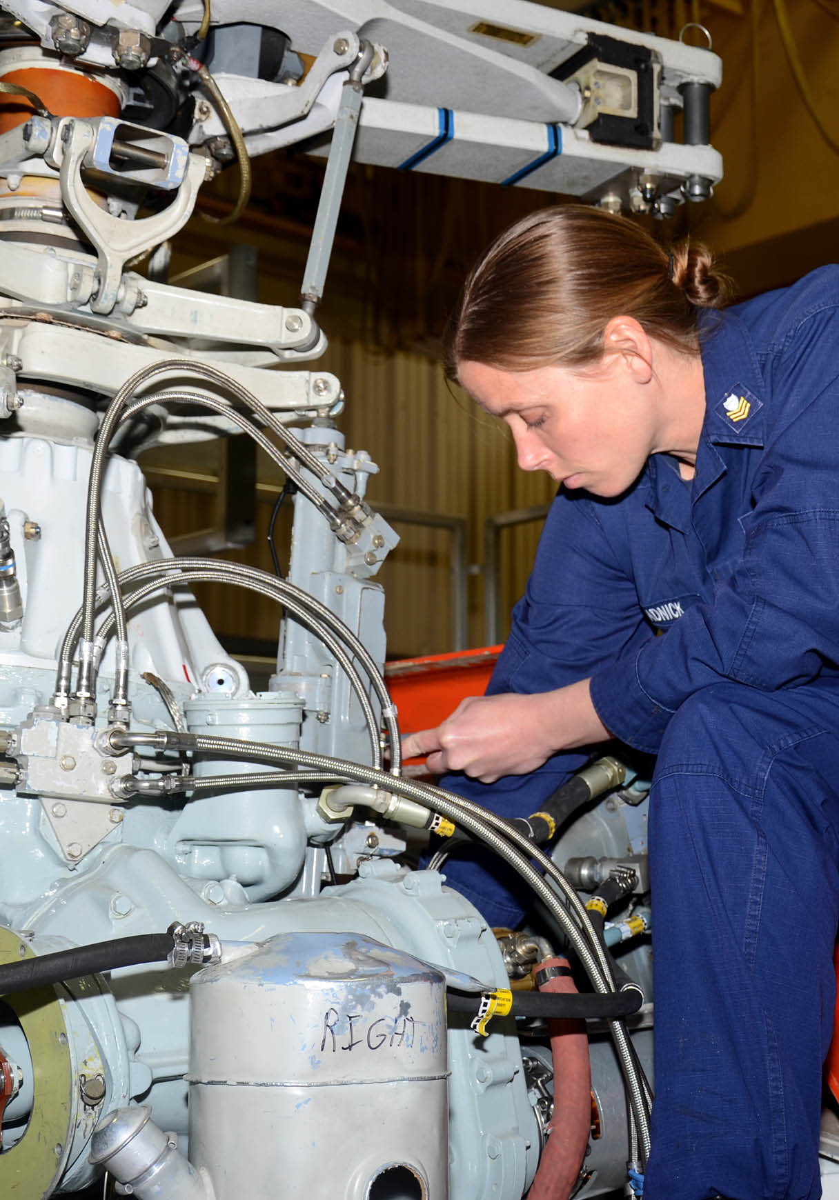 A woman wearing a blue shirt is working on a machine. AI generated content