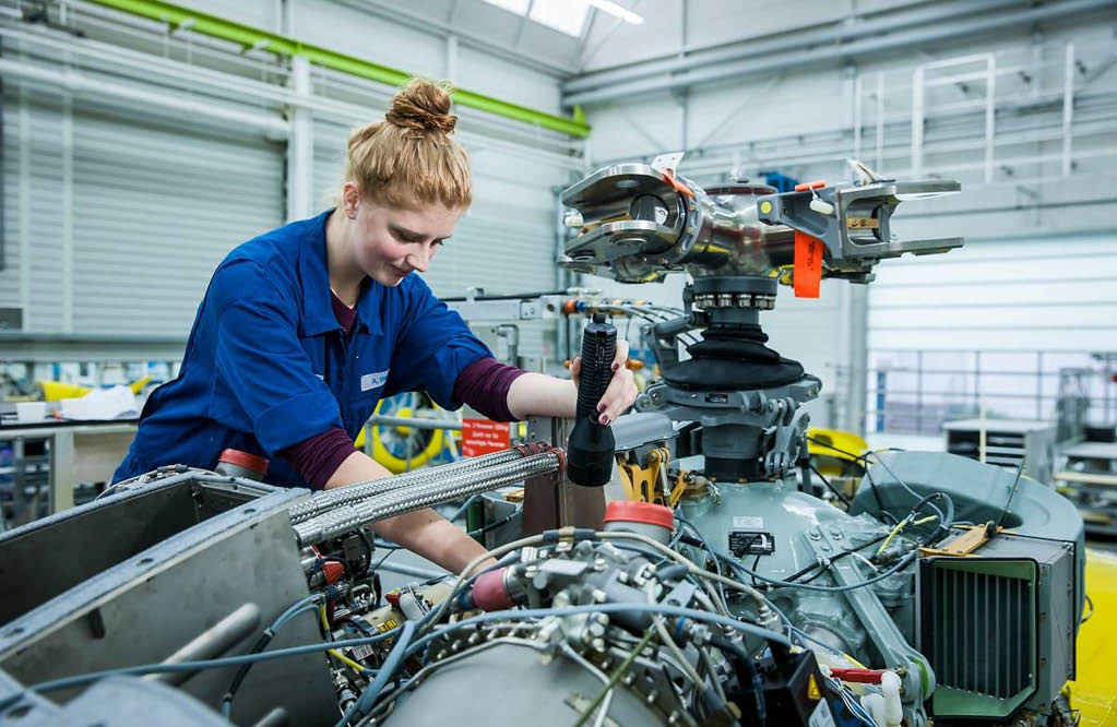 A woman in a blue shirt is working on a machine. AI generated content