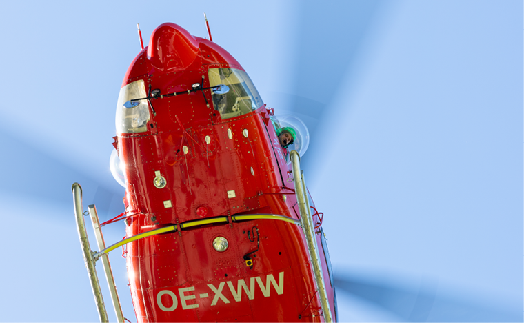 A red helicopter with a large propeller is flying in the sky. AI generated content
