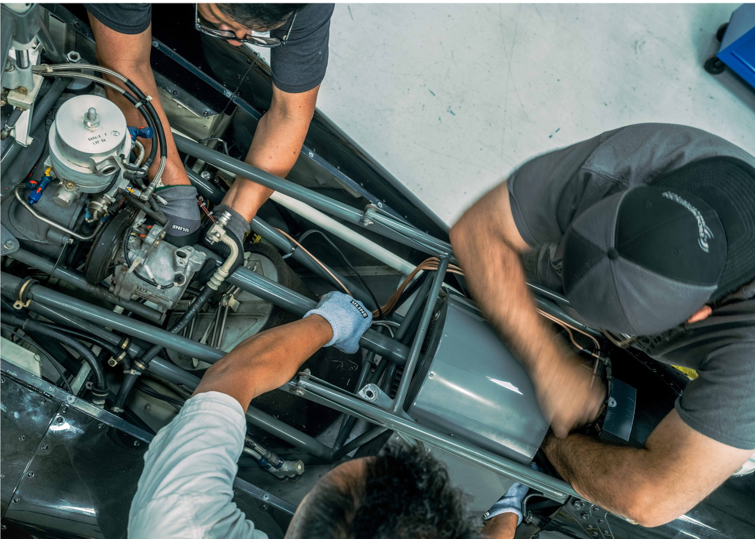 A group of men working on a car engine. AI generated content