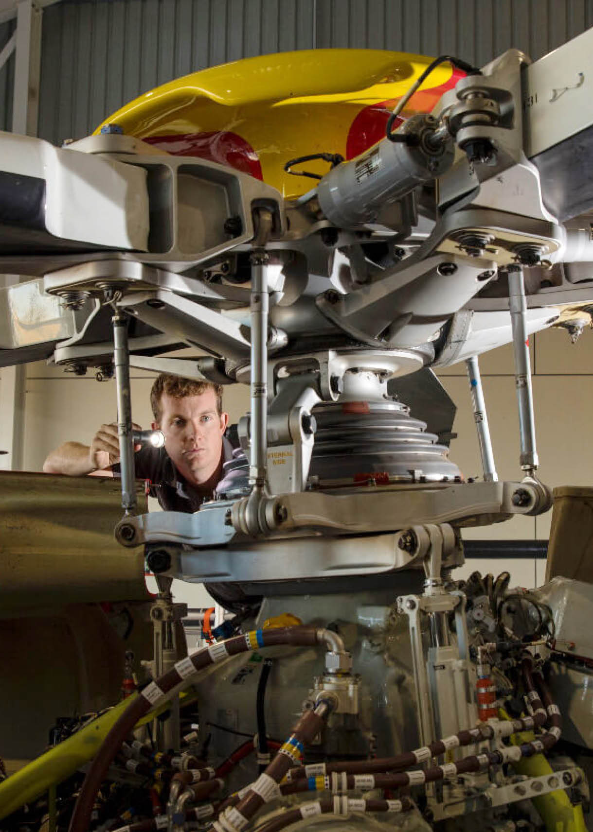 A man is working on a helicopter, specifically on the rotor. AI generated content