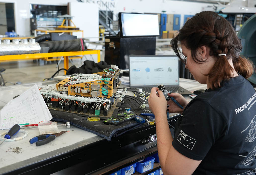 A woman is working on a laptop in a garage. AI generated content