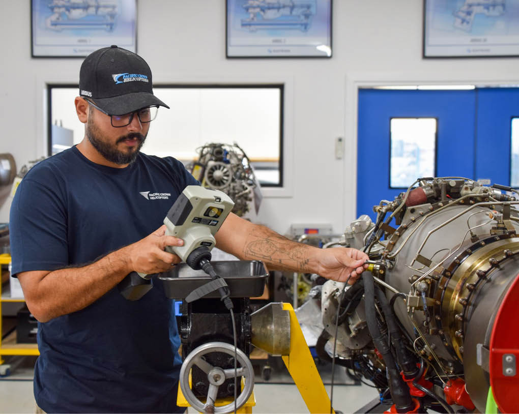 A man in a blue shirt is working on a jet engine. AI generated content