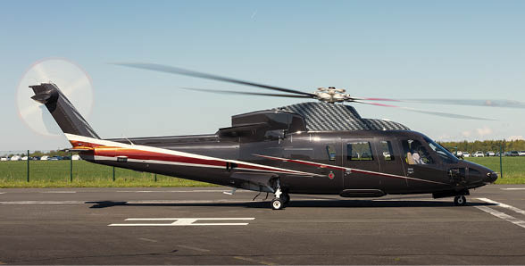 A black helicopter with a red stripe on the tail is sitting on a runway. AI generated content