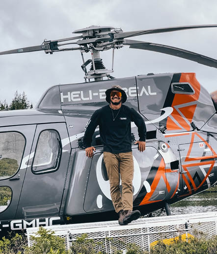 A man is standing on the skids of a helicopter. AI generated content