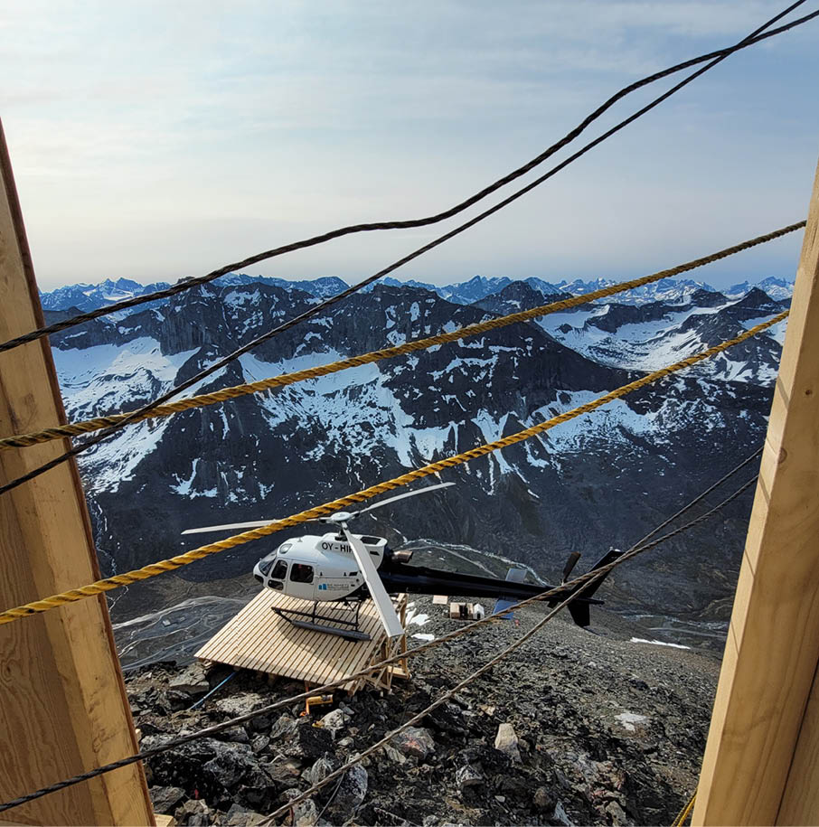 A plane is parked on a snowy mountain top. AI generated content