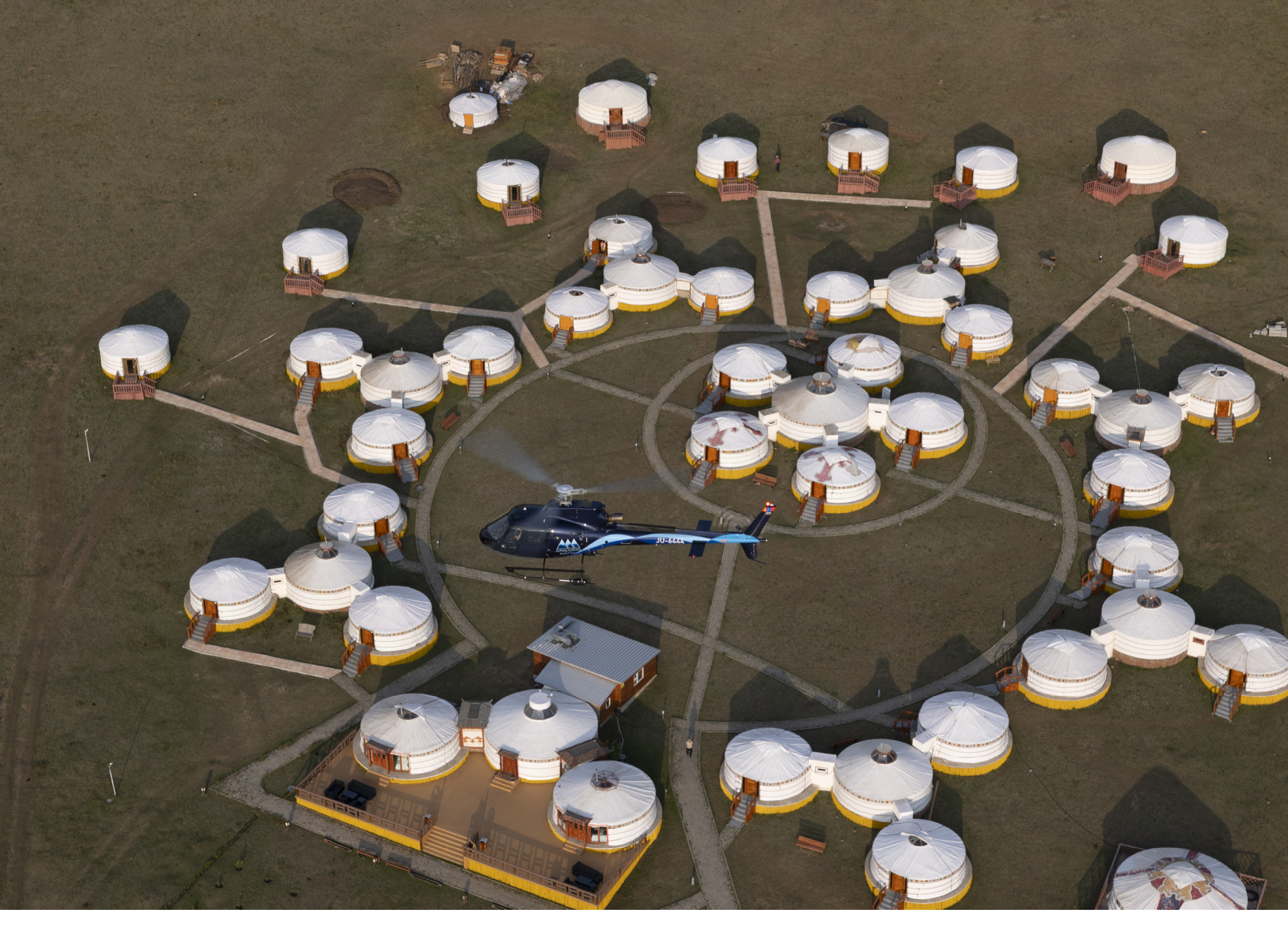 A helicopter is flying over a group of small houses. AI generated content