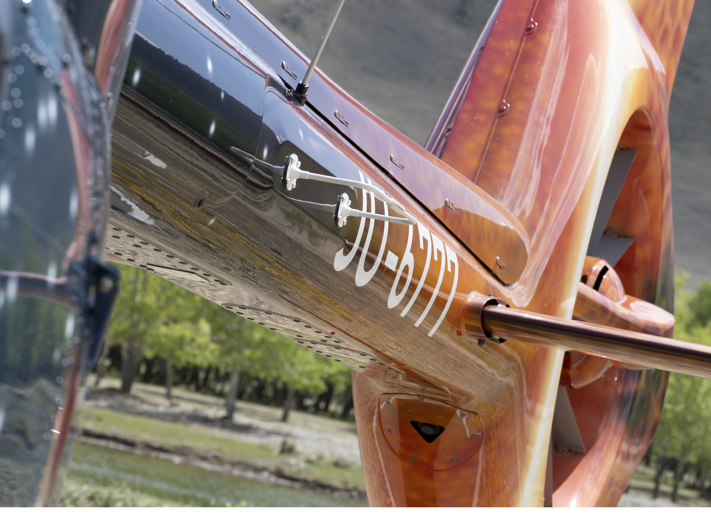 A helicopter with a red and orange tail has a picture of a woman on it. AI generated content