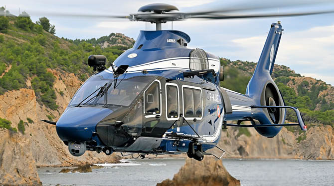 A blue helicopter is flying over a body of water. AI generated content