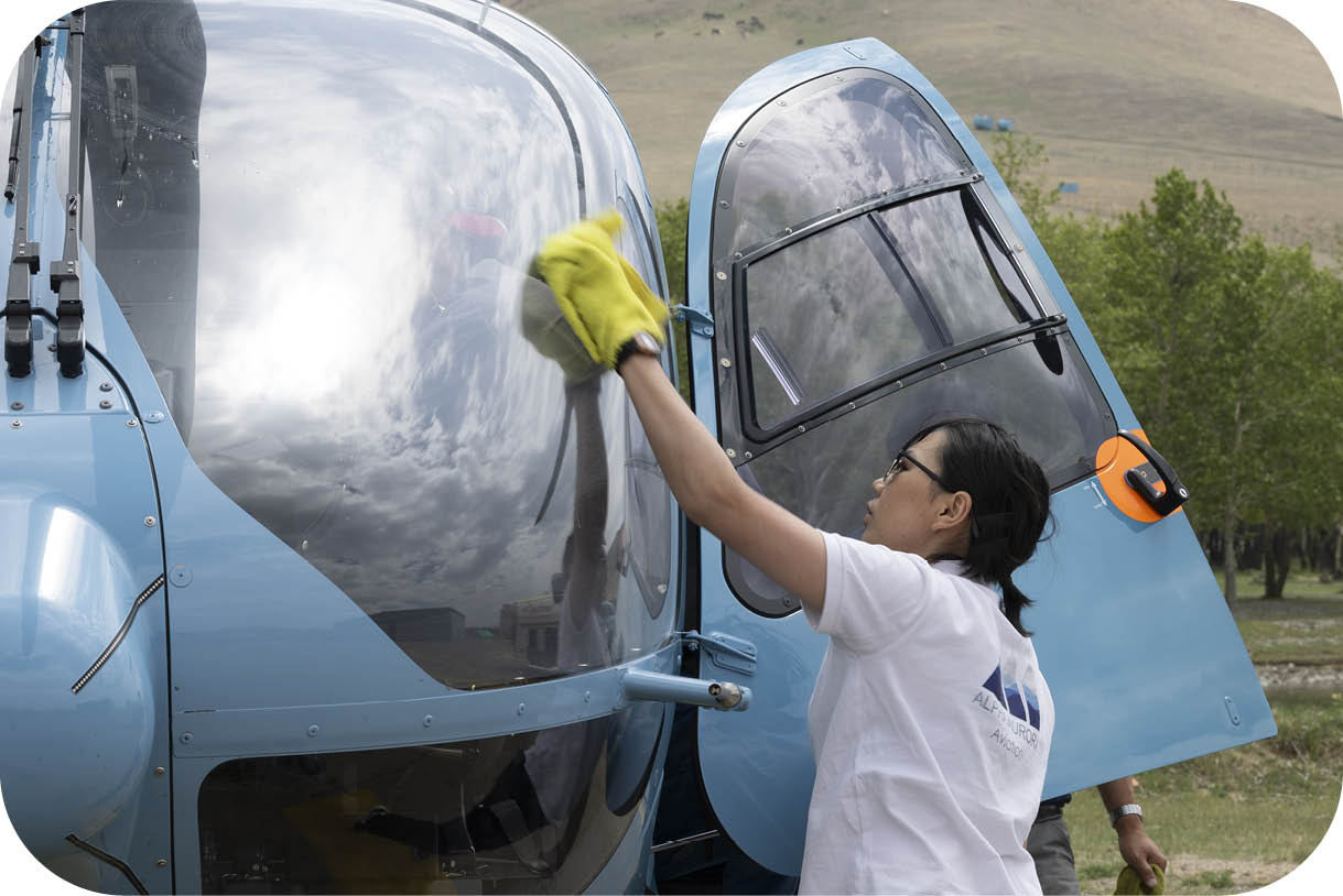 A woman wearing a white shirt is cleaning a helicopter window. AI generated content