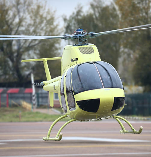 A yellow helicopter is on the ground with its blades spinning. AI generated content