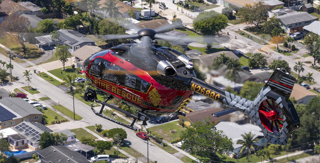 A red and yellow helicopter is flying over a neighborhood. AI generated content