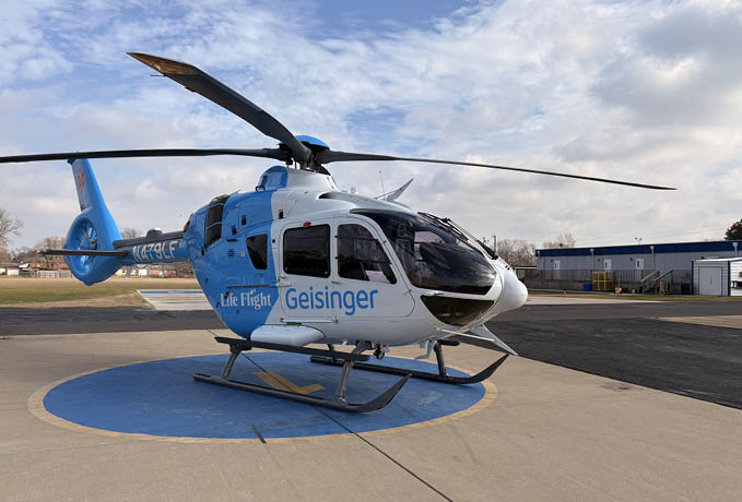 A blue and white helicopter with a large propeller is parked on the ground. AI generated content