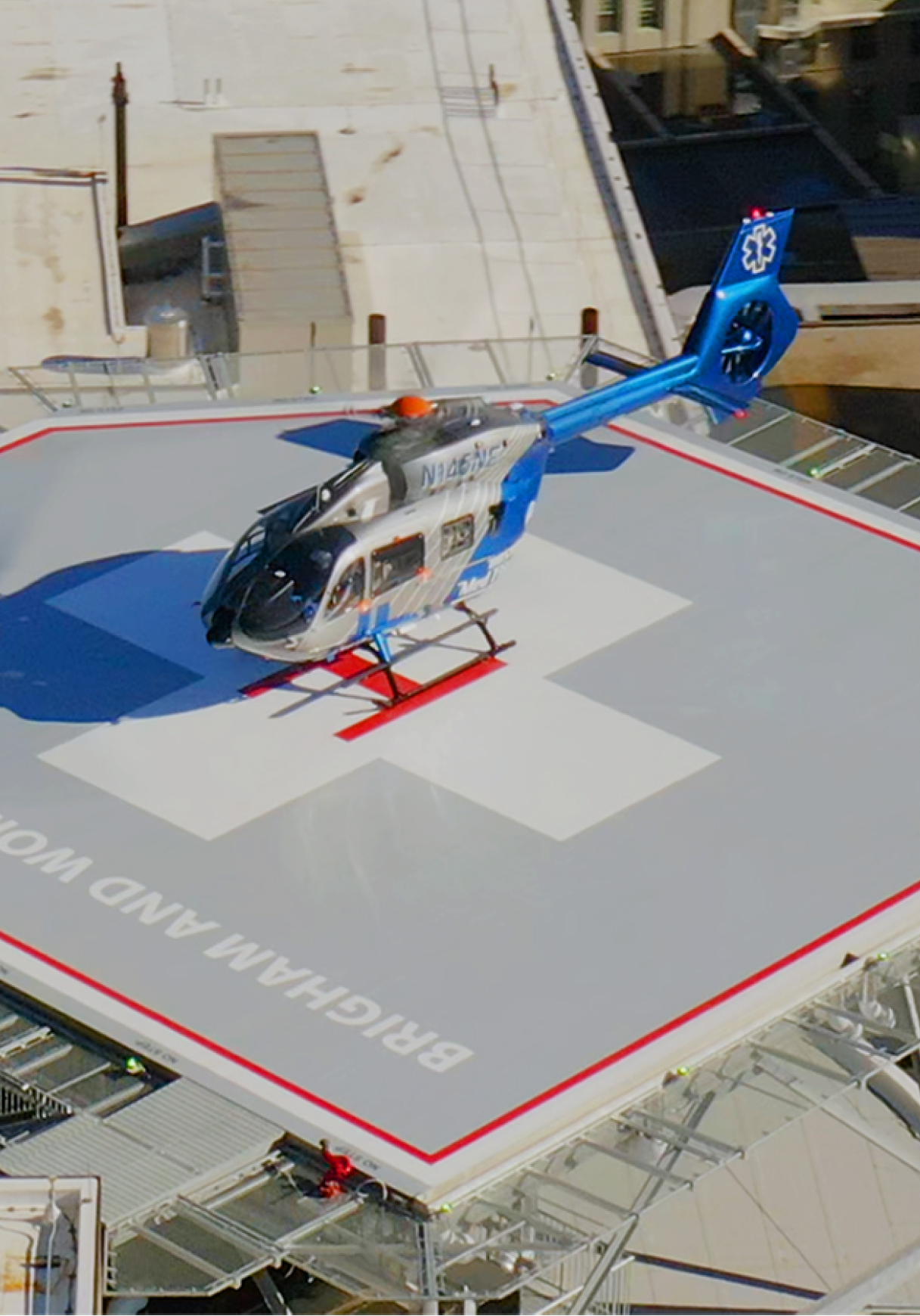 A helicopter is flying above a building with a red cross on its roof. AI generated content