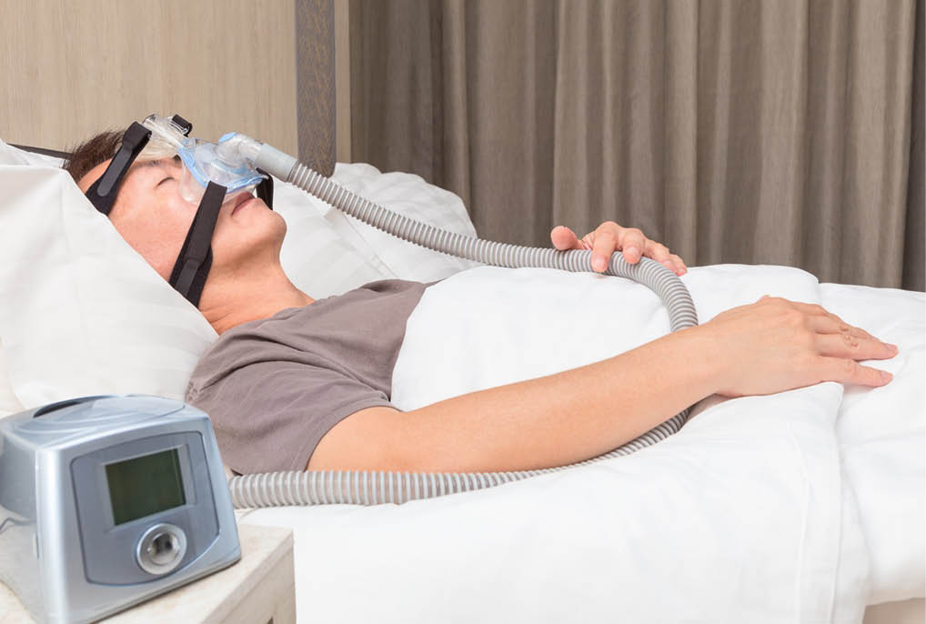 A man is lying in bed with a mask on his face, possibly sleeping or resting. AI generated content