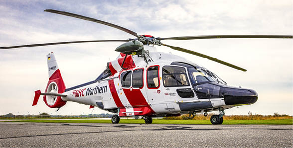 A large helicopter with a red and white body is parked on the ground. AI generated content