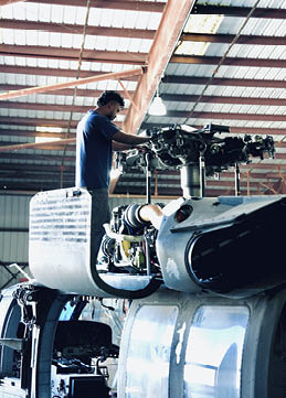 A man is working on an airplane in a hangar. AI generated content