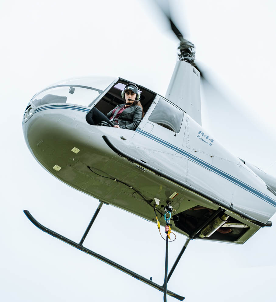 A person is sitting in a helicopter, flying through the air. AI generated content