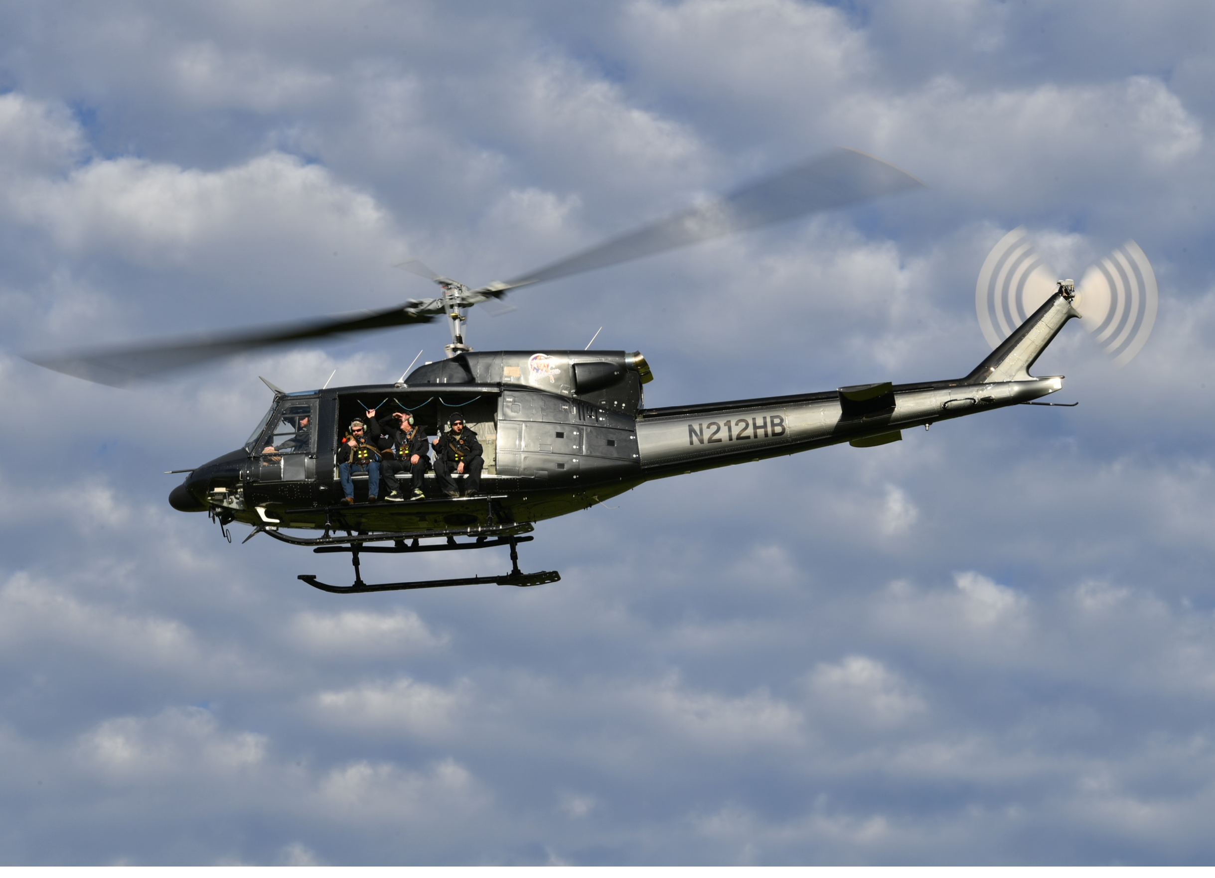 A helicopter with a group of people inside is flying through the sky. AI generated content