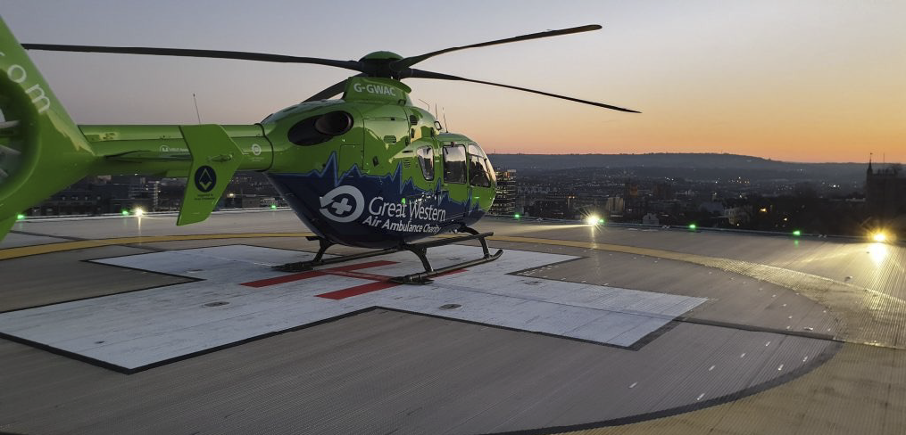 Two men wearing helmets and camouflage are sitting in a helicopter. AI generated content