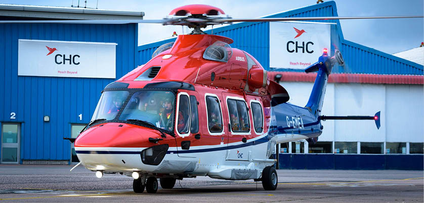 A red and white helicopter is parked in front of a blue building. AI generated content