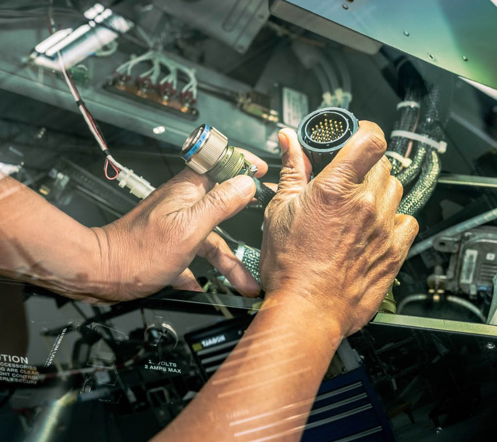 A person is working on a car engine, fixing a hose. AI generated content