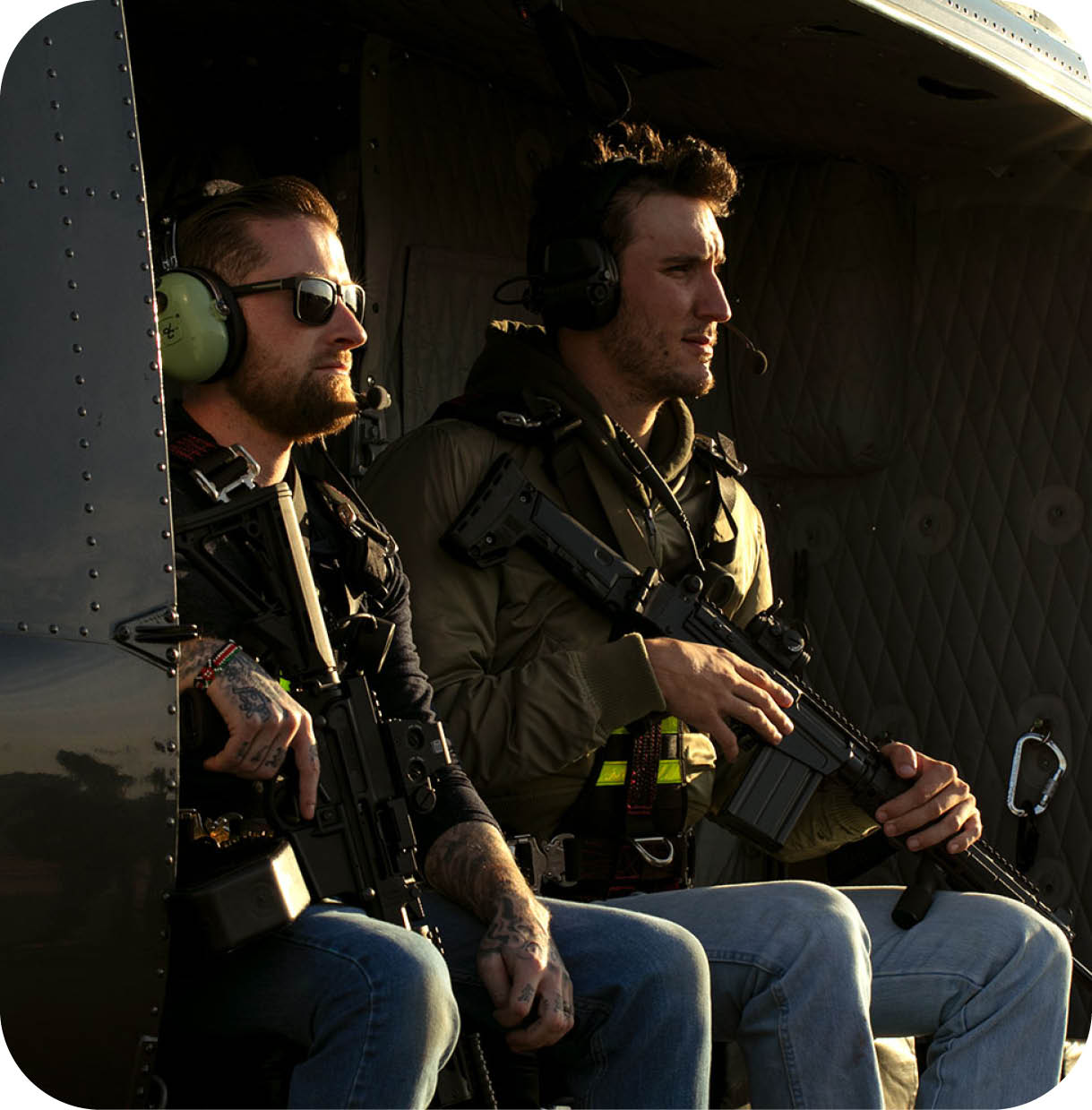 Two men wearing headphones and holding guns are sitting in a helicopter. AI generated content