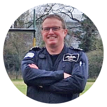 A man is standing in front of a yellow helicopter with a green and white stripe. AI generated content