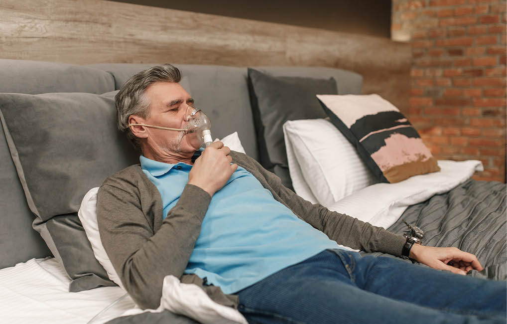 A man is lying on a bed, using an inhaler. AI generated content
