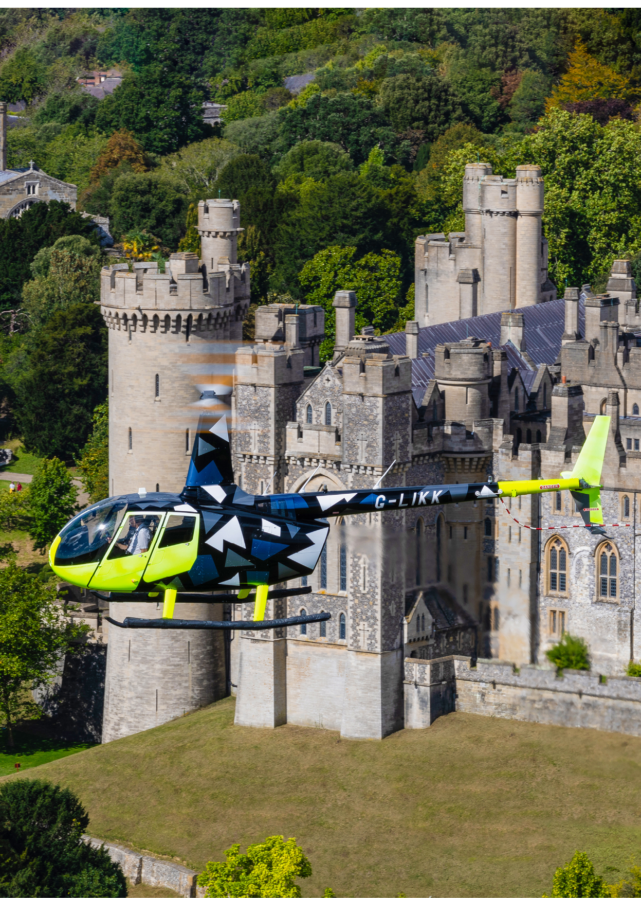 A yellow helicopter is flying over a castle with a large tower. AI generated content