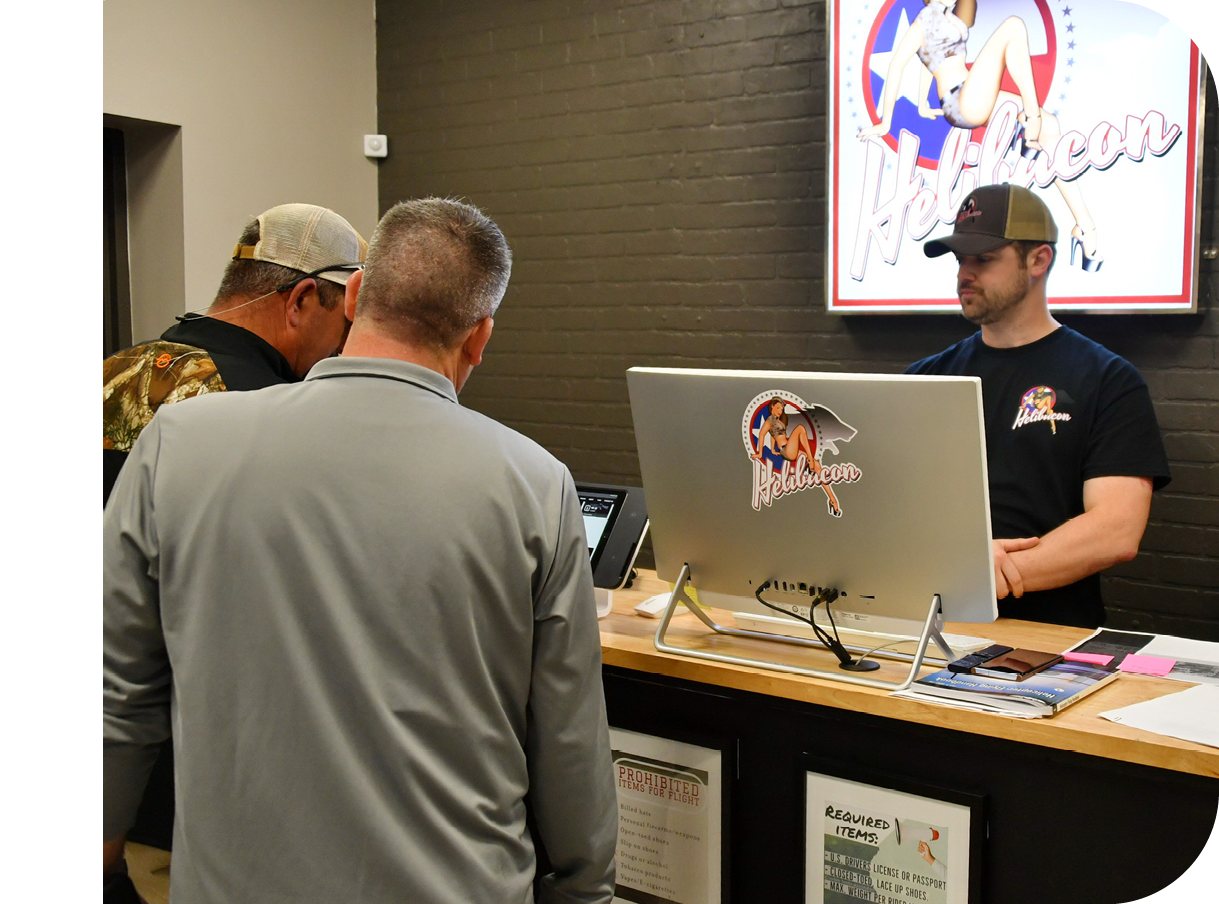 Three men are standing in front of a desk with a computer monitor on it. AI generated content