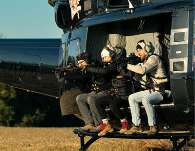 A group of people are sitting in a helicopter, with some of them holding guns. AI generated content