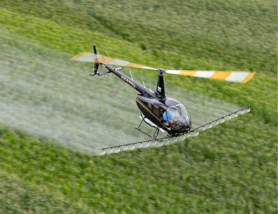 A helicopter is flying over a field, spraying water. AI generated content
