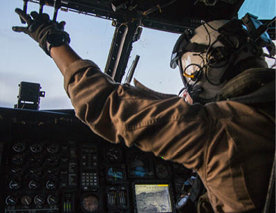 A man wearing a helmet and gloves is sitting in a cockpit of a plane. AI generated content