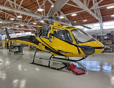 A yellow helicopter is parked in a hangar. AI generated content