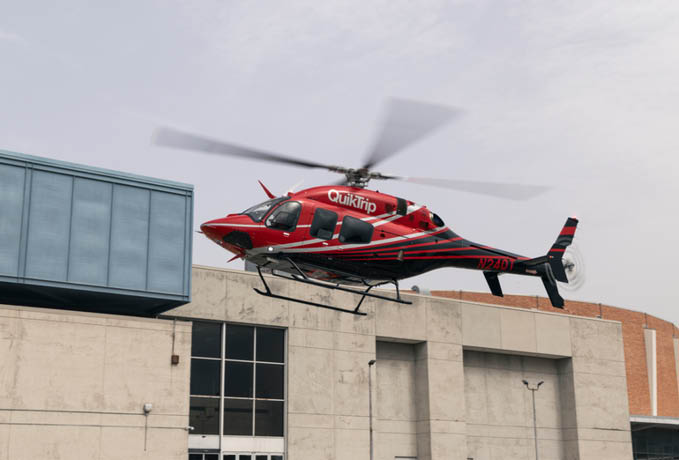 A red helicopter is flying above a building. AI generated content