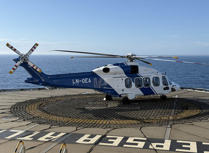 A blue and white helicopter with a red cross on the tail is parked on a deck. AI generated content