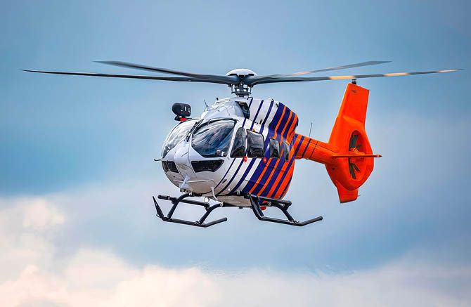 A red and white helicopter with a man in the cockpit. AI generated content