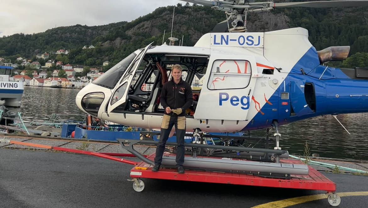 A man is standing in the doorway of a helicopter, which is parked on a tarmac. AI generated content