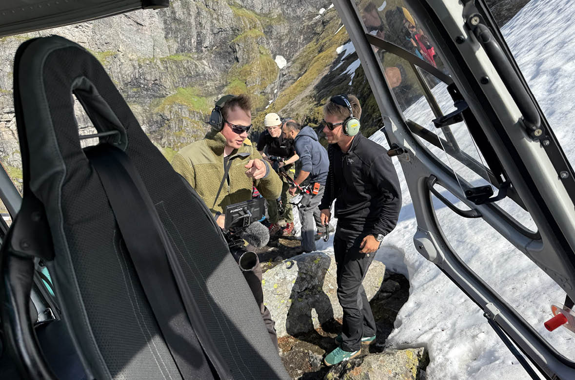 A group of people are standing on a snowy hill, with some of them wearing backpacks. AI generated content