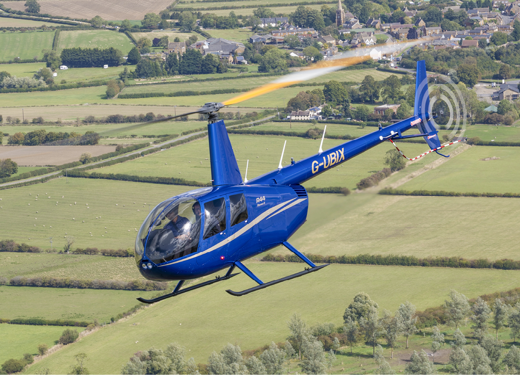 A blue helicopter is flying over a grassy field. AI generated content