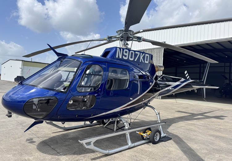 A blue helicopter with the number N900KO on the side is parked in a garage. AI generated content