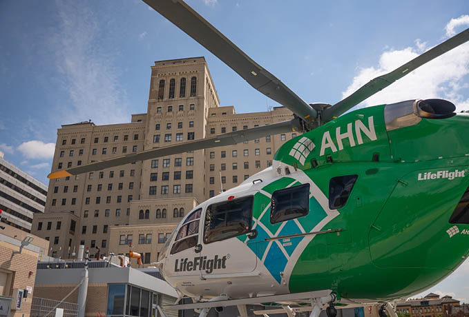 A green helicopter with the letters AHN on it. Description generated by AI