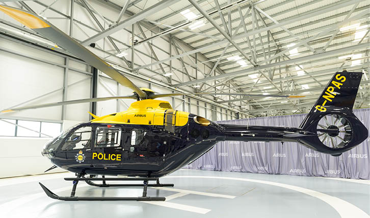 A yellow and black helicopter with the word police on it. Description generated by AI