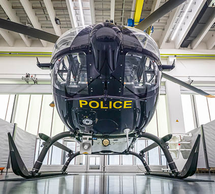 A black helicopter with the word police on the side. Description generated by AI