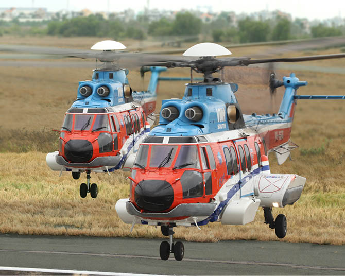 Two helicopters are flying in the air. Description generated by AI