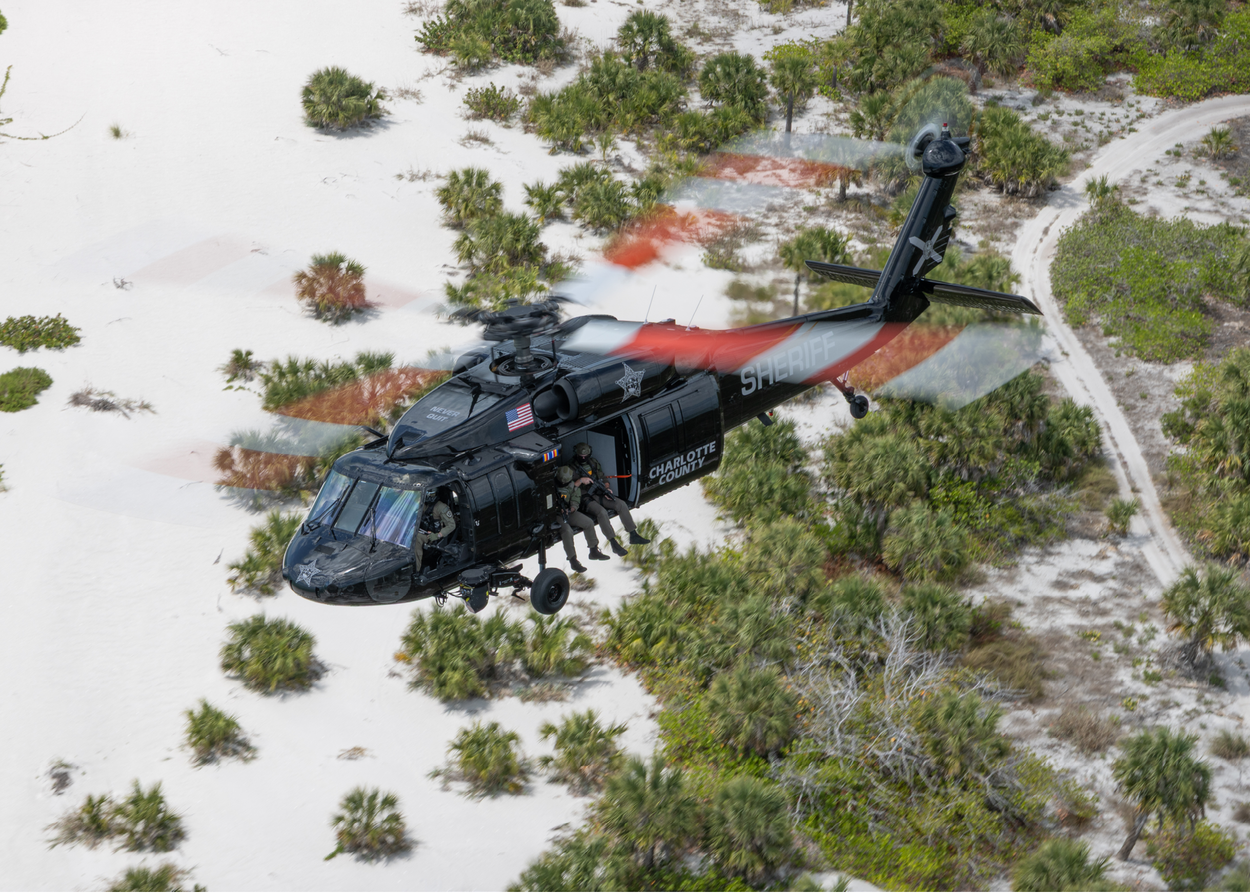 A helicopter is flying in the air. Description generated by AI