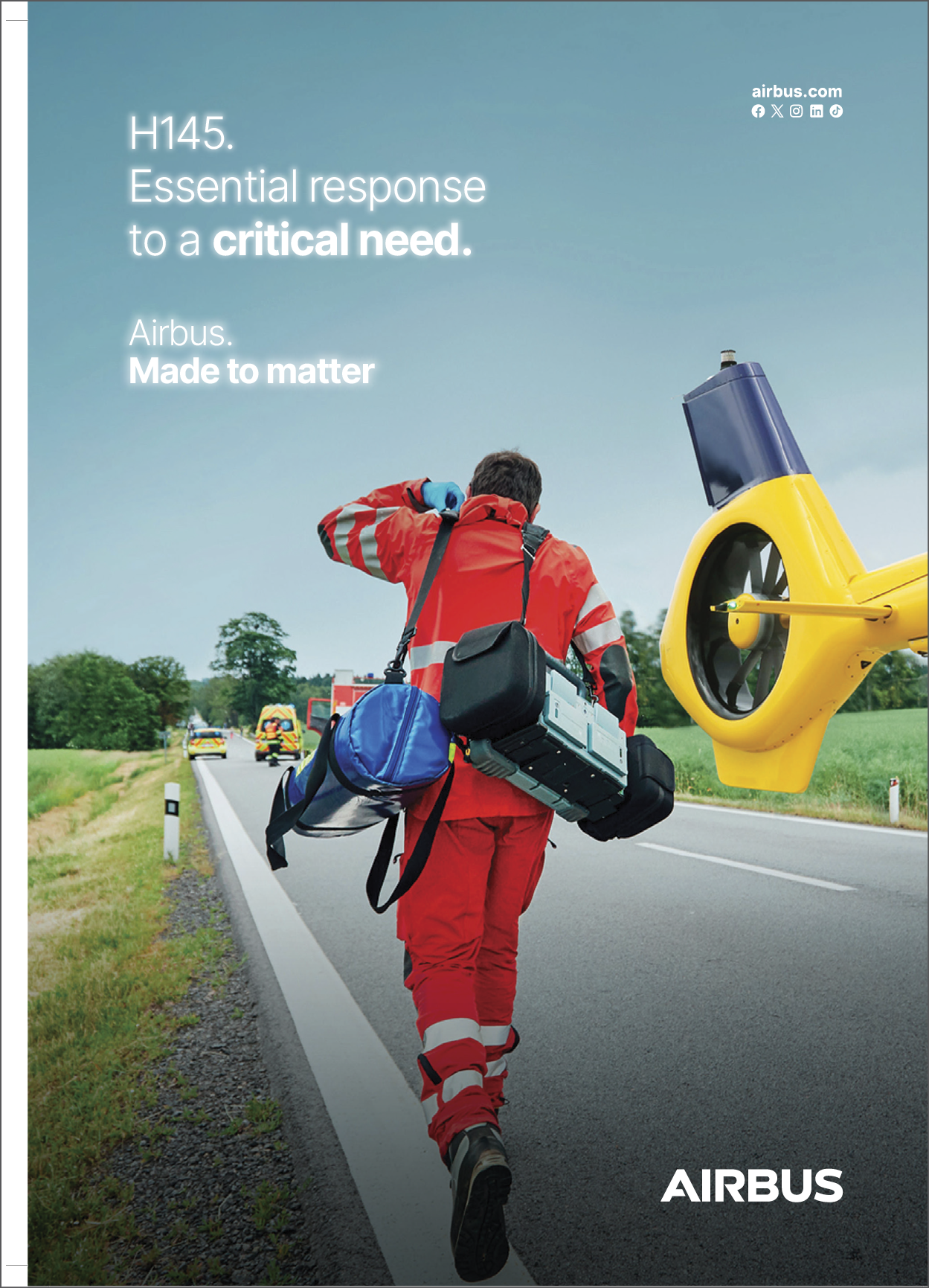 A man wearing a red and white uniform is carrying a bag and a suitcase. Description generated by AI