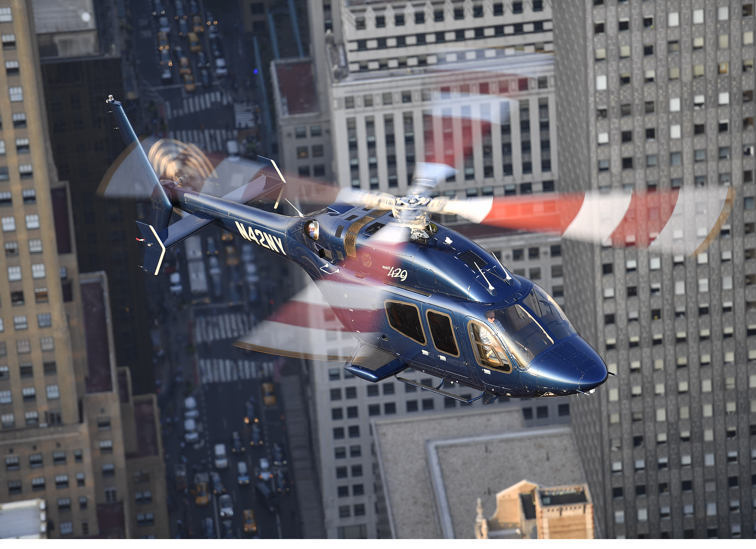 A helicopter flying over a city. Description generated by AI